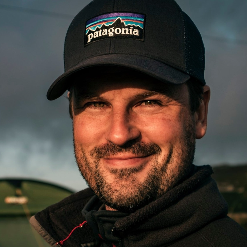 Portrait head shot photo of Edward Felton wearing a patagonia baseball cap